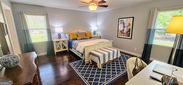 bedroom with multiple windows, ceiling fan, baseboards, and wood finished floors