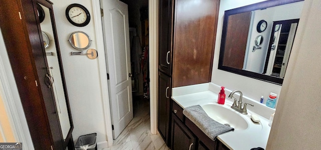 bathroom with marble finish floor and vanity