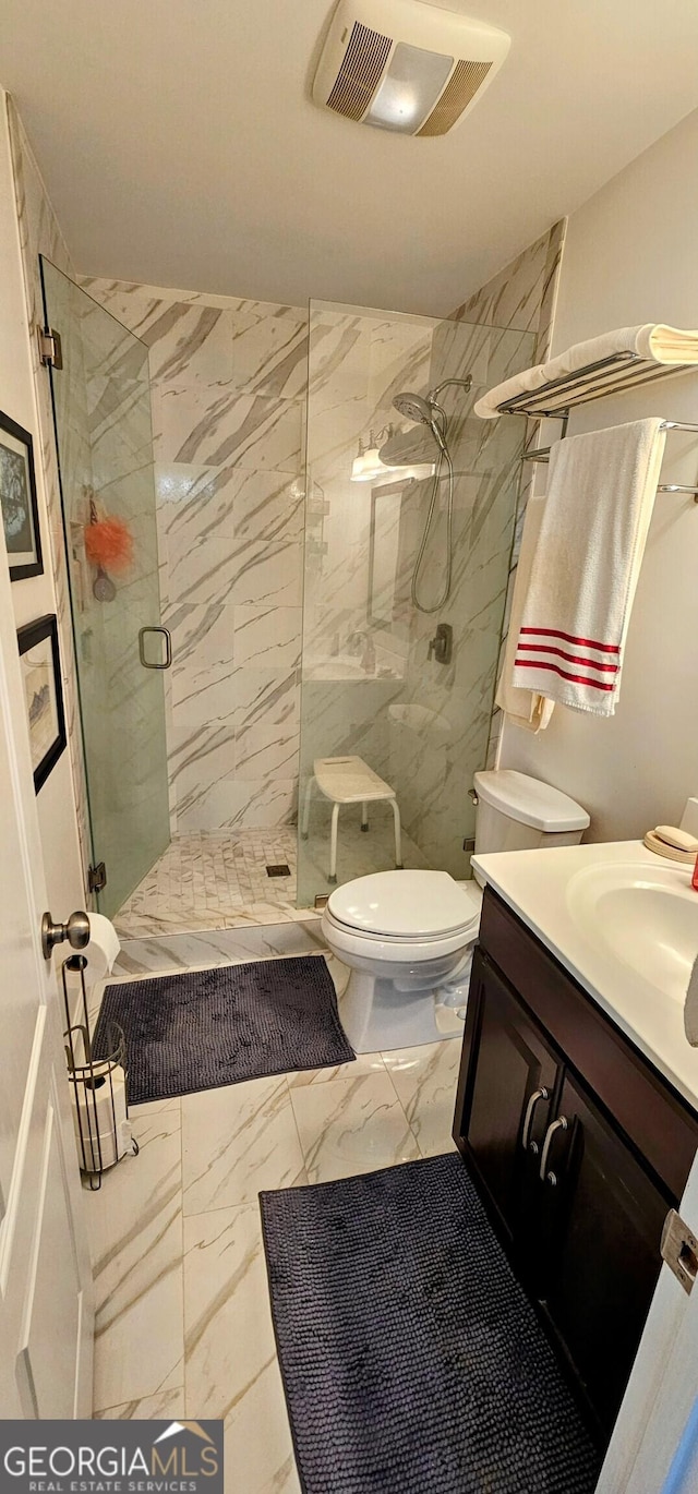 full bath featuring vanity, visible vents, a marble finish shower, toilet, and marble finish floor