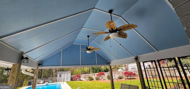 view of swimming pool with a shed, a yard, fence private yard, an outdoor structure, and ceiling fan