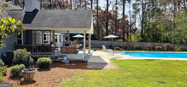 view of pool with a fenced in pool, a lawn, a deck, and fence