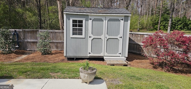 view of shed with a fenced backyard