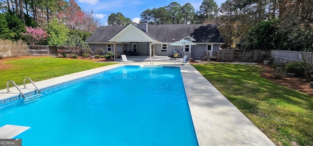 view of pool featuring a yard, a fenced in pool, a fenced backyard, and a patio area