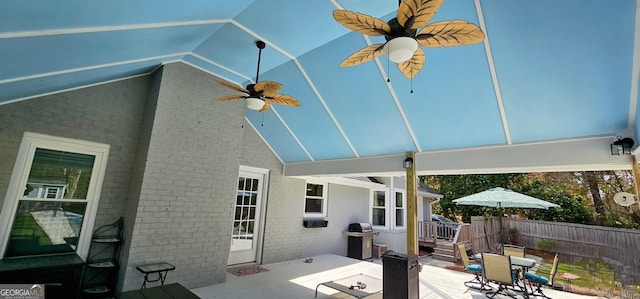 view of patio with outdoor dining area, grilling area, and fence