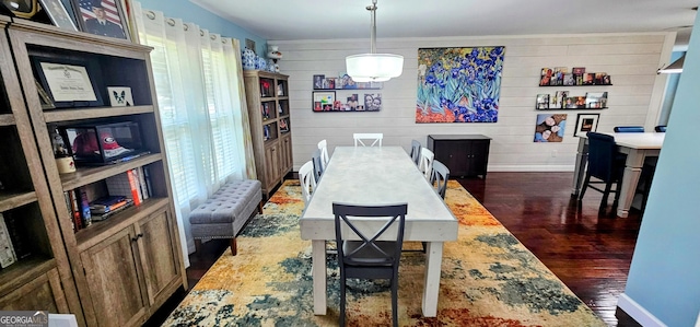 dining area featuring baseboards and dark wood-style flooring