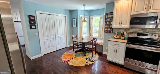 kitchen with decorative backsplash, baseboards, appliances with stainless steel finishes, and dark wood-style flooring