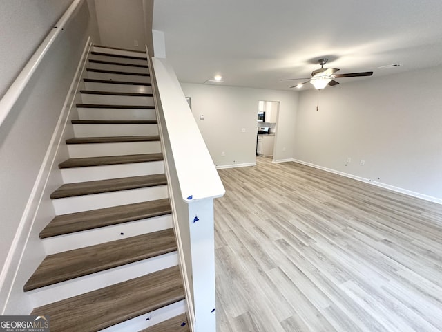 staircase featuring recessed lighting, baseboards, a ceiling fan, and wood finished floors