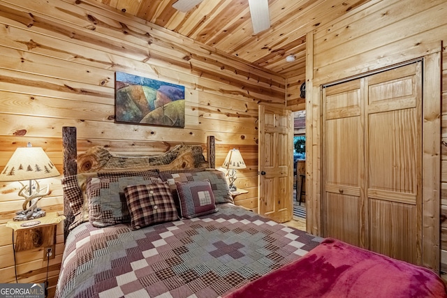 bedroom with a closet, wood walls, and wooden ceiling