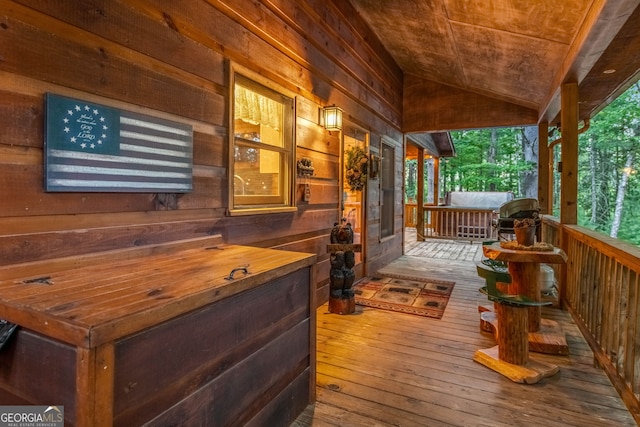 wooden terrace with grilling area and a porch