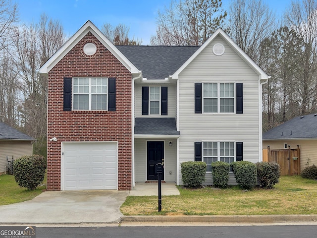 traditional home featuring a front lawn, concrete driveway, an attached garage, and a shingled roof