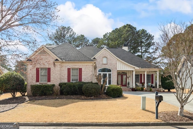 9620 Coastal Pointe Dr, Villa Rica, GA 30180 - view of front facade featuring french doors, roof with shingles, a front yard, brick siding, and a chimney