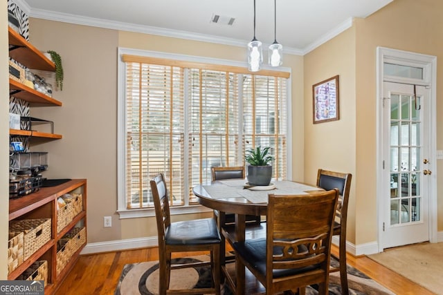 9620 Coastal Pointe Dr, Villa Rica, GA 30180 - dining space with visible vents, ornamental molding, baseboards, and wood finished floors