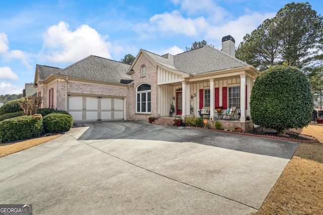 9620 Coastal Pointe Dr, Villa Rica, GA 30180 - view of front facade featuring brick siding, a shingled roof, a porch, concrete driveway, and a garage