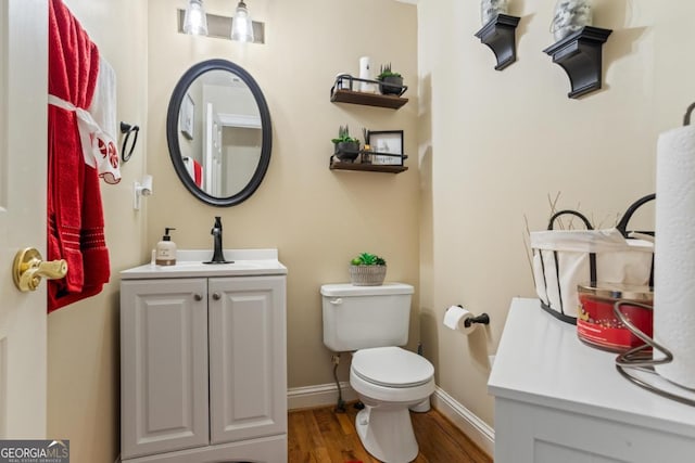9620 Coastal Pointe Dr, Villa Rica, GA 30180 - bathroom with toilet, vanity, baseboards, and wood finished floors
