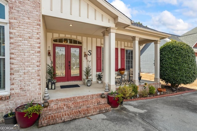 9620 Coastal Pointe Dr, Villa Rica, GA 30180 - doorway to property featuring brick siding, covered porch, french doors, and board and batten siding