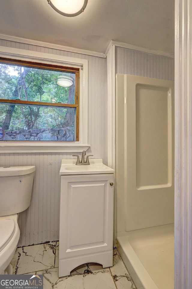 full bathroom featuring marble finish floor, toilet, vanity, and walk in shower