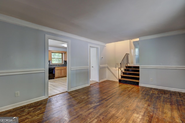 unfurnished living room with ornamental molding, hardwood / wood-style flooring, baseboards, and stairs
