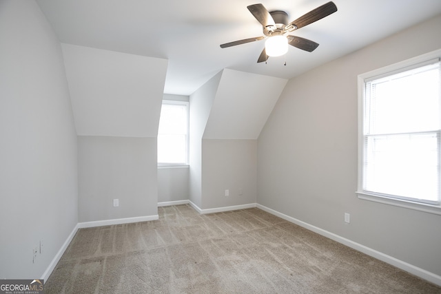 additional living space with vaulted ceiling, a ceiling fan, baseboards, and carpet floors