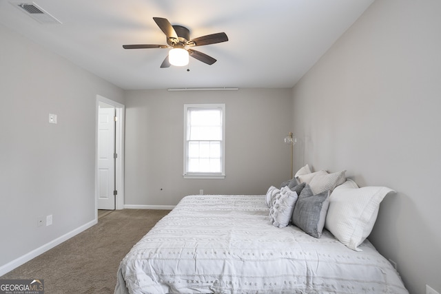 bedroom with visible vents, baseboards, carpet, and a ceiling fan