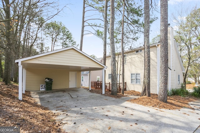 exterior space featuring driveway and a chimney