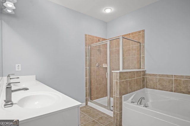 bathroom with tile patterned flooring, a garden tub, a stall shower, and a sink