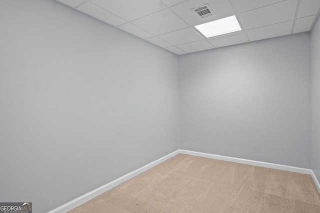 unfurnished room featuring visible vents, carpet flooring, a paneled ceiling, and baseboards