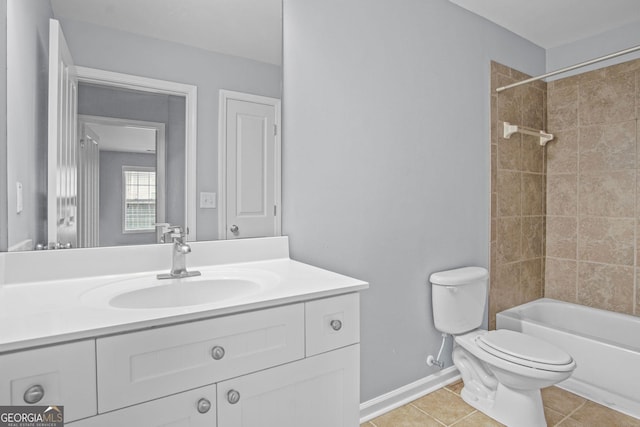 bathroom with baseboards, toilet, vanity, and tile patterned flooring