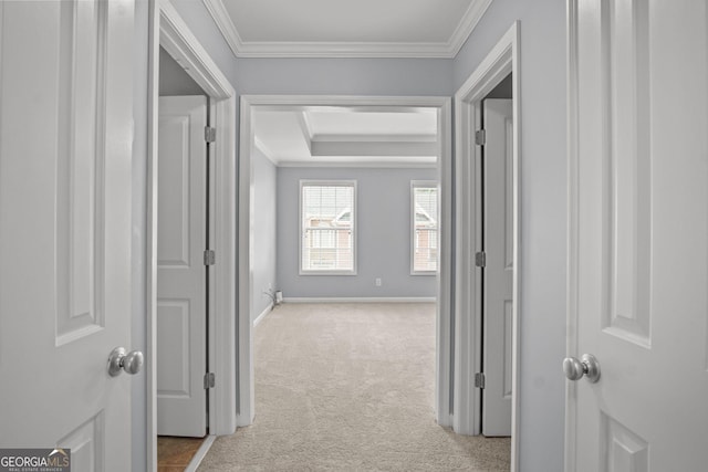 hall with baseboards, carpet floors, and ornamental molding