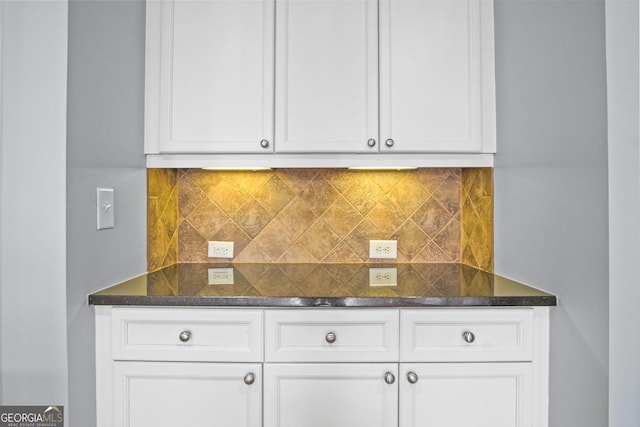 kitchen featuring backsplash and white cabinetry