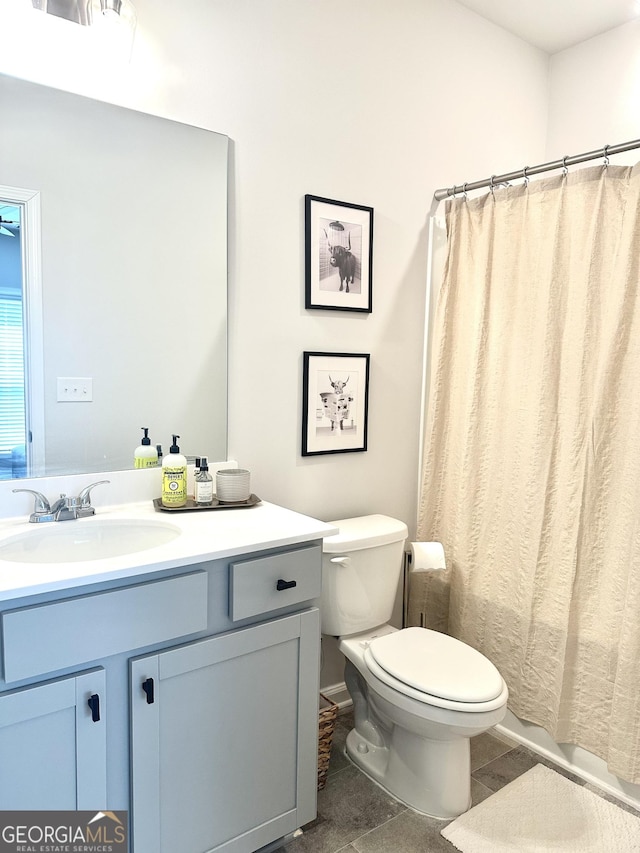 bathroom featuring toilet and vanity