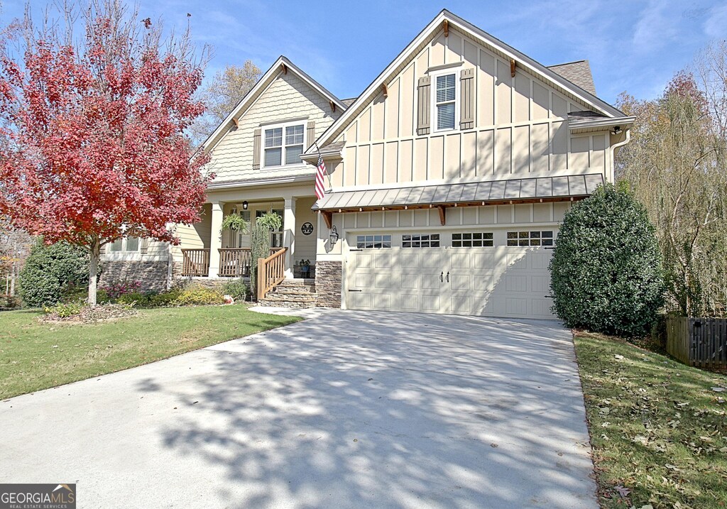 18 Vanderbilt Pointe Ln, Newnan, GA 30265 - craftsman-style home with board and batten siding, a garage, concrete driveway, covered porch, and a front yard