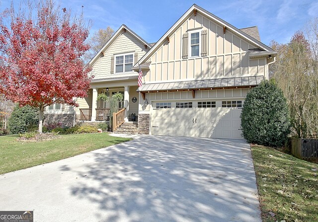 18 Vanderbilt Pointe Ln, Newnan, GA 30265 - craftsman-style home with board and batten siding, a garage, concrete driveway, covered porch, and a front yard