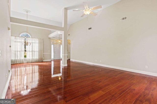 4838 Netherlands Pl, Flowery Branch, GA 30542 - unfurnished living room with a chandelier, ceiling fan, wood finished floors, and high vaulted ceiling