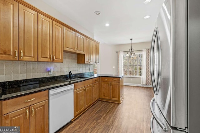 4838 Netherlands Pl, Flowery Branch, GA 30542 - kitchen featuring white dishwasher, freestanding refrigerator, dark wood-style flooring, decorative backsplash, and recessed lighting