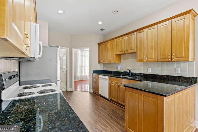 4838 Netherlands Pl, Flowery Branch, GA 30542 - kitchen with white appliances, dark wood-style floors, dark stone countertops, decorative backsplash, and recessed lighting