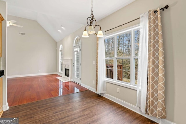 4838 Netherlands Pl, Flowery Branch, GA 30542 - unfurnished dining area featuring a chandelier, wood finished floors, lofted ceiling, and a high end fireplace