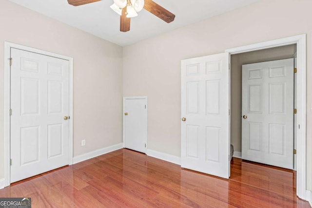 4838 Netherlands Pl, Flowery Branch, GA 30542 - unfurnished bedroom with wood finished floors and ceiling fan