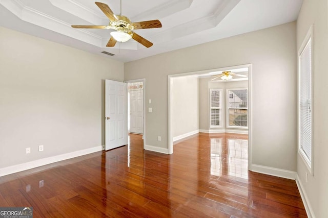 4838 Netherlands Pl, Flowery Branch, GA 30542 - unfurnished room featuring a raised ceiling, ceiling fan, and wood finished floors