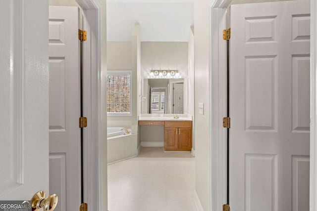 4838 Netherlands Pl, Flowery Branch, GA 30542 - bathroom with vanity, a bath, and tile patterned flooring