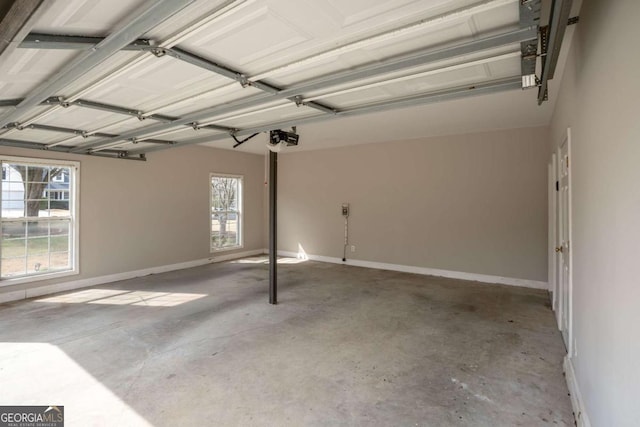4838 Netherlands Pl, Flowery Branch, GA 30542 - garage with a garage door opener and baseboards