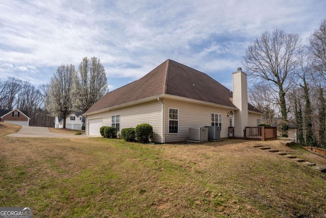 4838 Netherlands Pl, Flowery Branch, GA 30542 - view of side of home with a chimney, a lawn, an attached garage, and a shingled roof