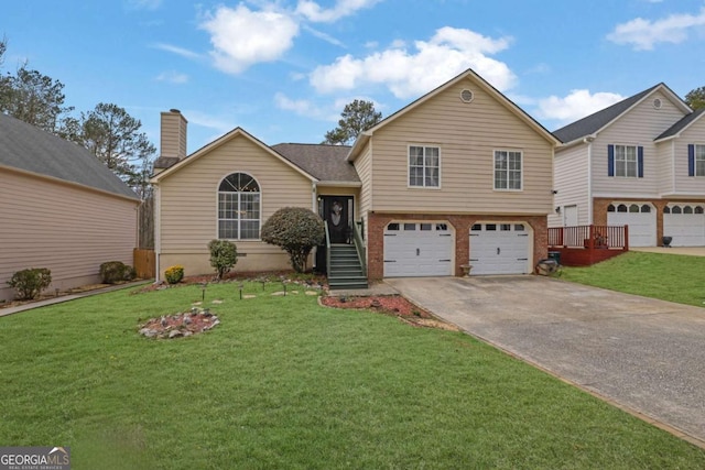 tri-level home featuring a front yard, brick siding, a garage, and driveway