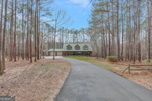 view of front facade with a porch, a garage, and driveway