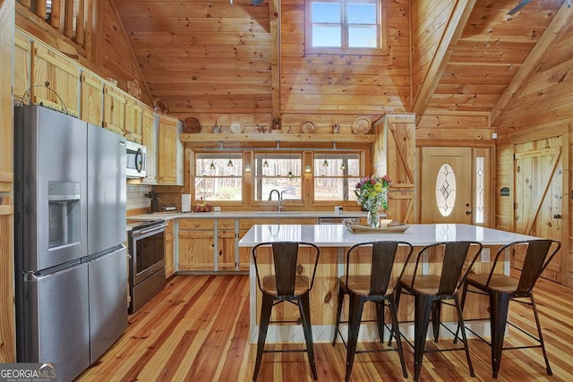 kitchen featuring light wood-type flooring, a sink, appliances with stainless steel finishes, wooden ceiling, and lofted ceiling