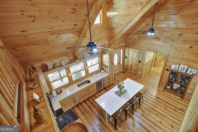 living area featuring beam ceiling, light wood-style flooring, wood ceiling, and ceiling fan