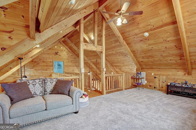 interior space featuring wooden walls, vaulted ceiling with beams, ceiling fan, carpet floors, and wooden ceiling