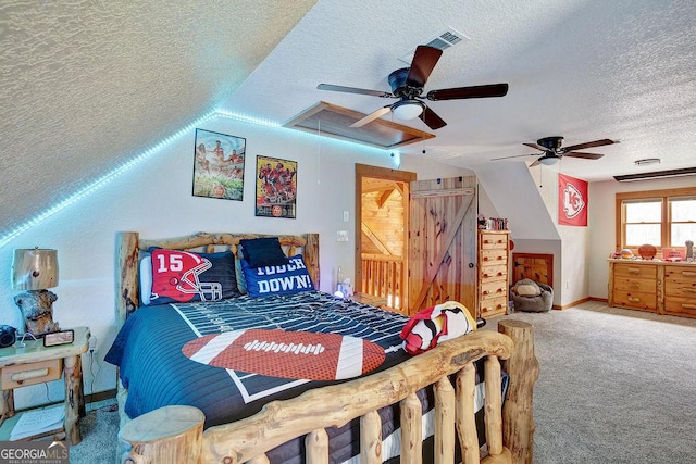 bedroom featuring baseboards, carpet, attic access, a textured ceiling, and a ceiling fan