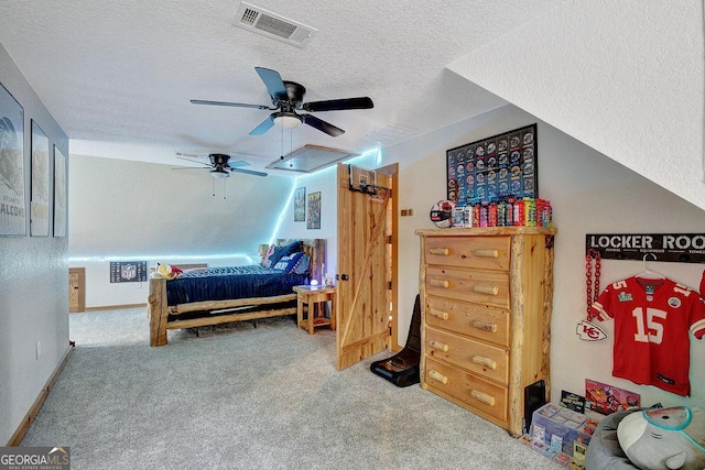 carpeted bedroom featuring visible vents, ceiling fan, a textured ceiling, and baseboards