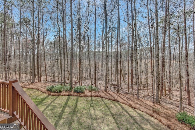 view of yard with a view of trees