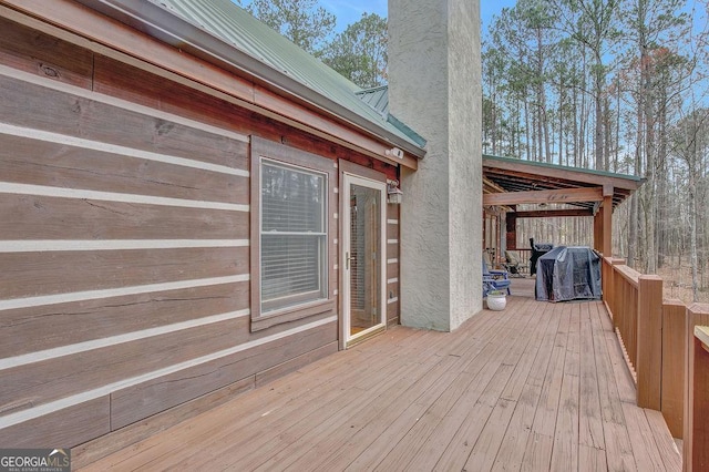 wooden terrace featuring grilling area